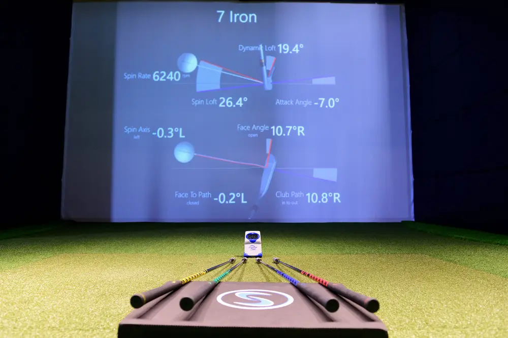 TrackMan shot data on a bay screen